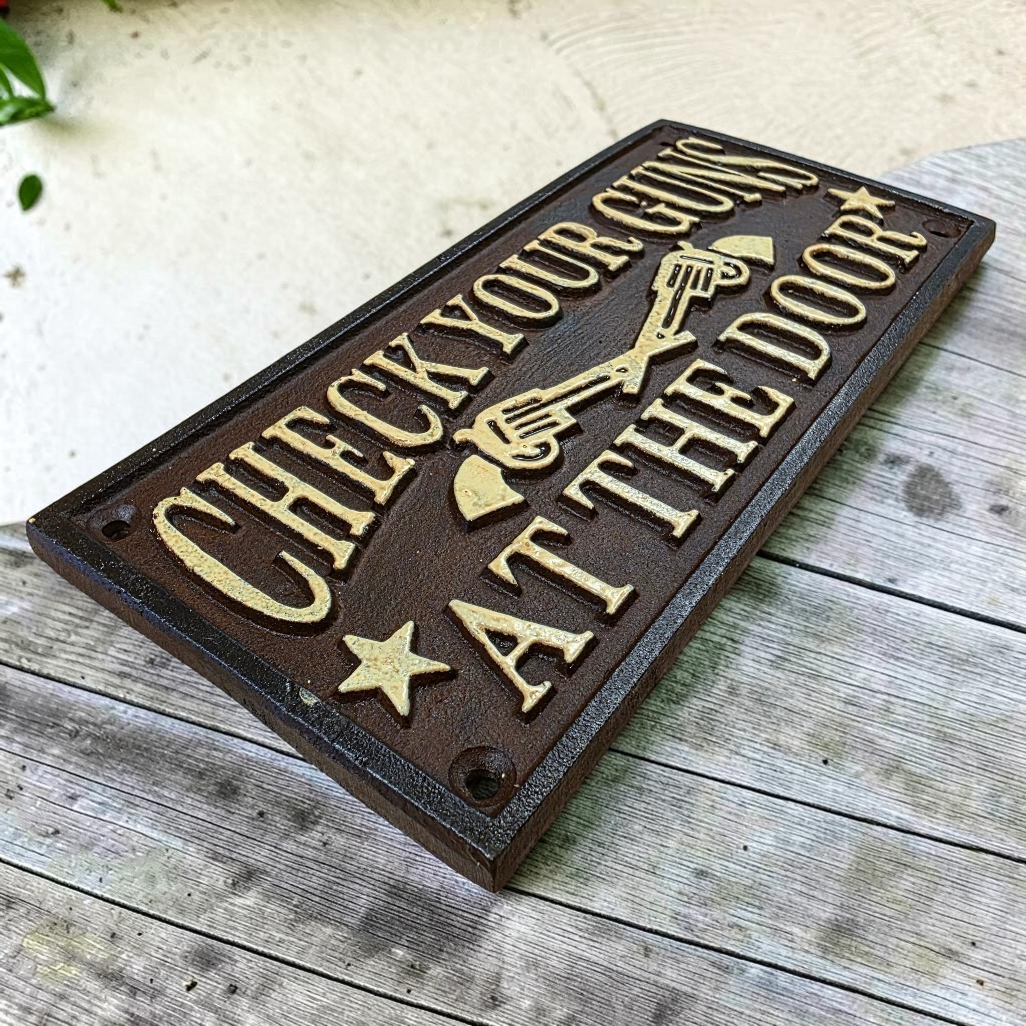 Check Your Guns At The Door Cast Iron Wall Plaque Sign With Antique Finish (7.75" x 3.5") - Jones Peak