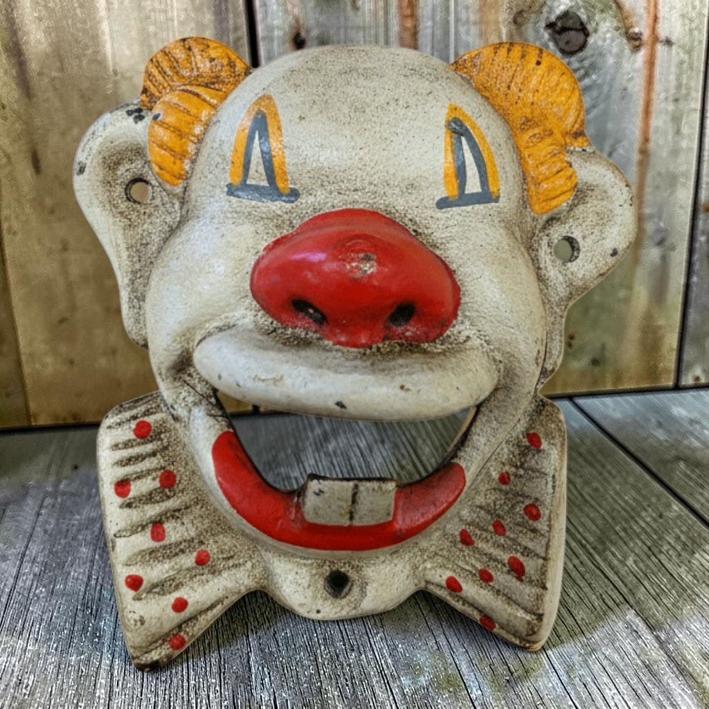 Jones Peak cast iron clown wall bottle opener with red nose, red lips, and red polka dot bow tie.