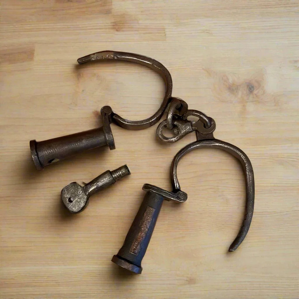Sing Sing Prison Cast Iron Handcuffs close-up with brass tag - Jones Peak