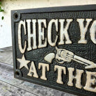 Check Your Guns At The Door Cast Iron Wall Plaque Sign With Antique Finish (7.75" x 3.5") - Jones Peak
