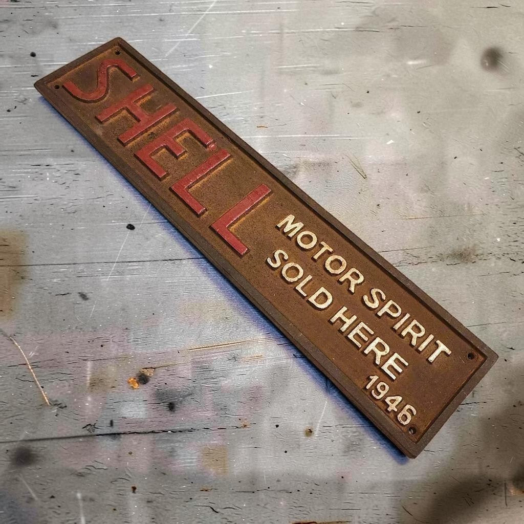 Shell 1946 Cast Iron Embossed Plaque With Painted Antique Finish (13.25" x 3") - Jones Peak