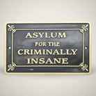 Asylum for the Criminally Insane Cast Iron Plaque product detail image with clear view of the piece.