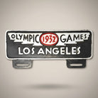 Jones Peak 1932 Los Angeles Olympic Games aluminum license plate topper with antique patina finish.
