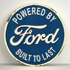 Jones Peak Ford Built To Last round embossed metal sign with blue background and white lettering.