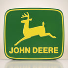 Jones Peak John Deere logo metal magnet, green with yellow deer and text. Vintage collectible accent.