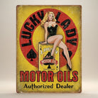 Jones Peak Lucky Lady Motor Oil Metal Sign featuring a pin-up girl sitting on a motor oil can. Red and yellow distressed metal.