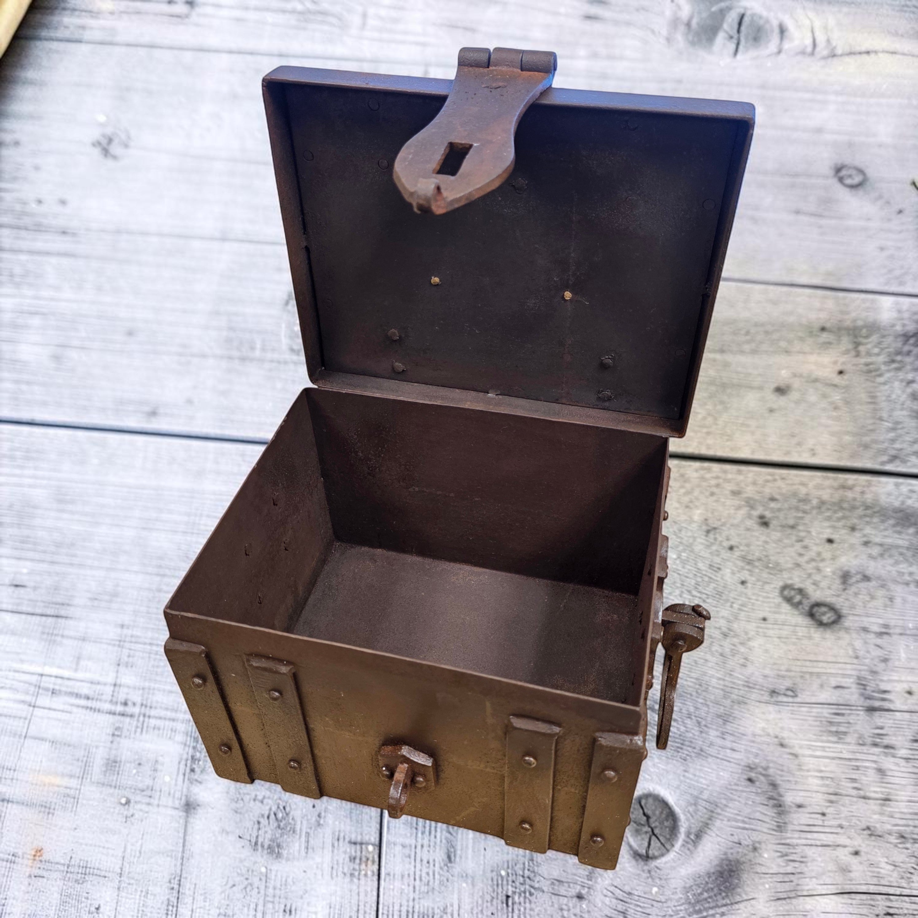 Jones Peak Winchester 1866 cast iron strong box with brass tag, distressed finish, decorative storage.