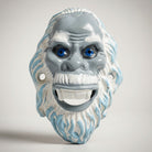 Jones Peak Abominable Snowman cast iron bottle opener with blue eyes and white fur details.
