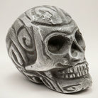 Jones Peak antique finish aluminum skull paperweight with carved details and distressed texture.