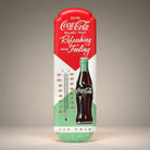 Jones Peak Coca-Cola thermometer with embossed metal design, featuring a classic bottle and thermometer scale.