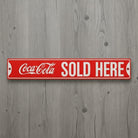 Jones Peak Coca-Cola Sold Here embossed metal street sign, red with white lettering, vintage advertising.
