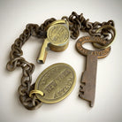 Jones Peak New York Insane Asylum guard key and whistle set with a heavy chain and oval tag, cast iron with antiqued patina.