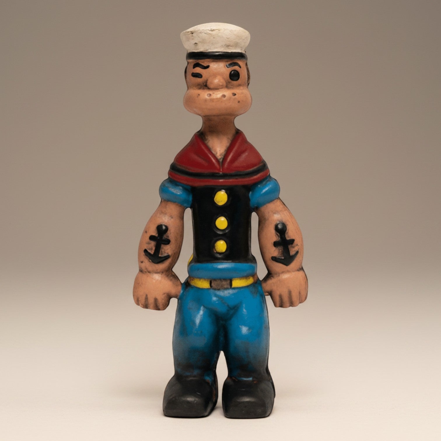 Jones Peak Sailor Cast Iron Coin Bank with hand-painted antique patina. Features blue pants, black shirt, red collar, and white hat.