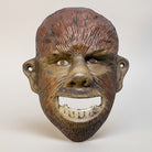 Jones Peak Wolfman cast iron wall bottle opener, hand-painted with antiqued finish. Functional decor for bars, garages, and kitchens.